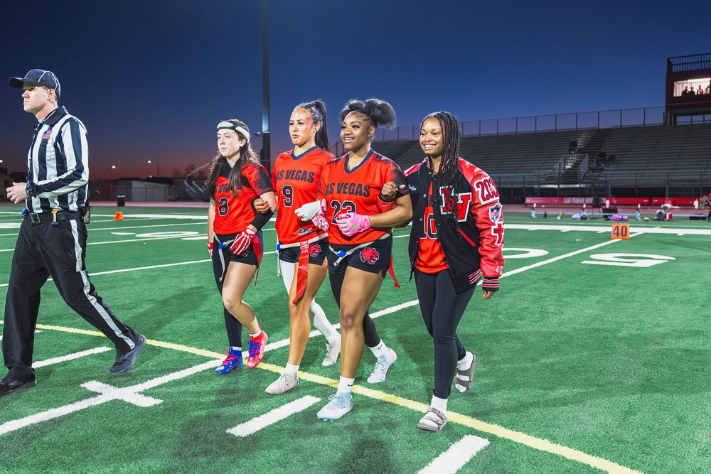 Girls flag football players captains walking to mid field
