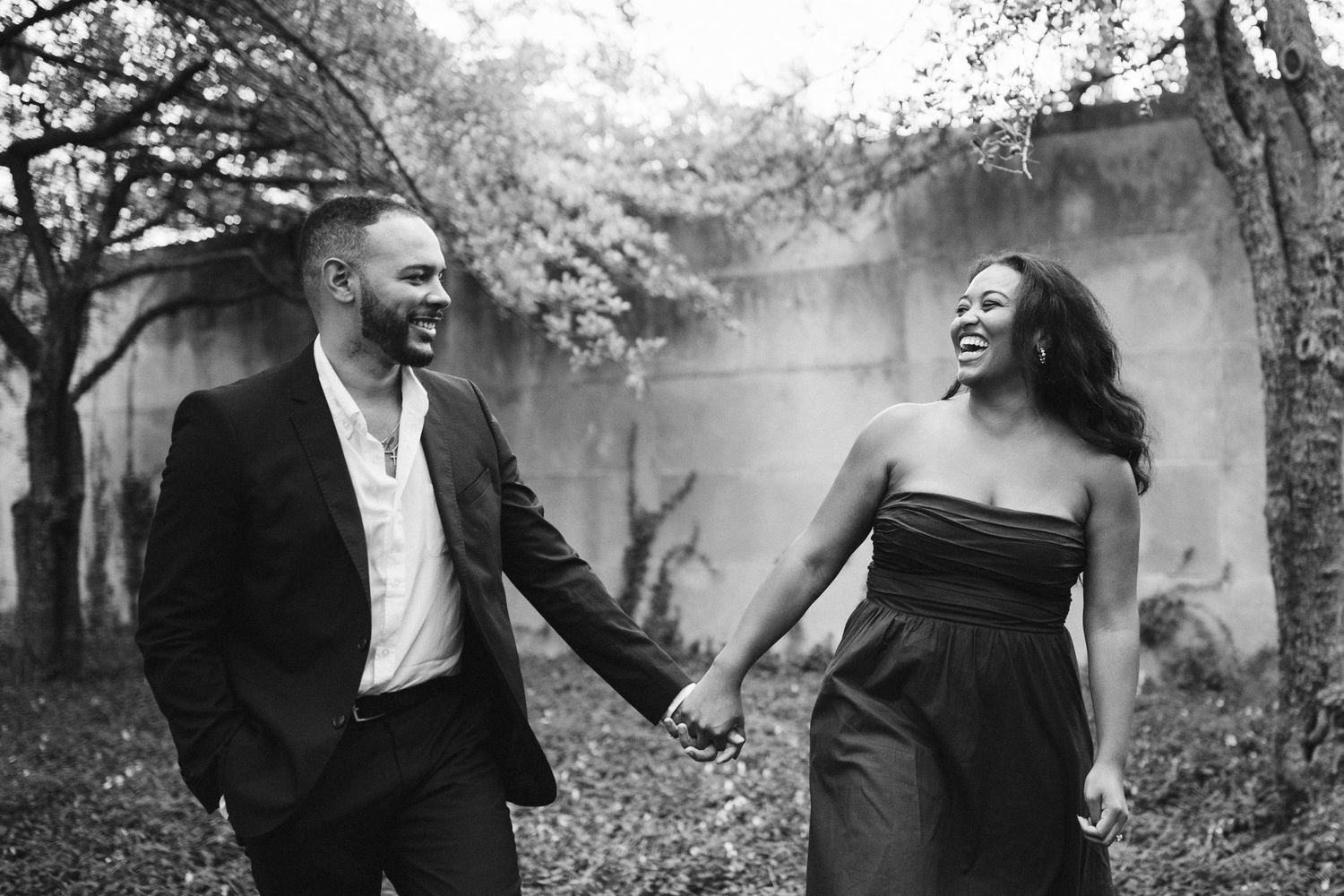 Black and white photo series showing joyful moments of laughter and interaction outdoors in a natural setting.