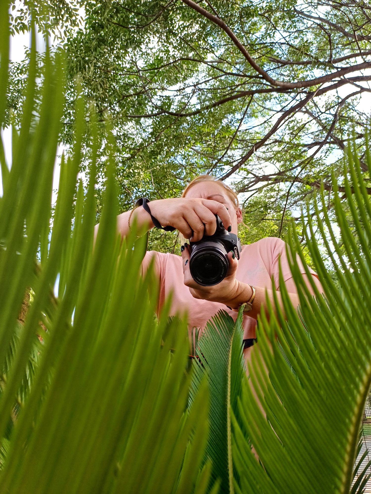 Photography student examining her shot outdoors during GETPIX 9-month course, developing technical and creative skills in natural light.