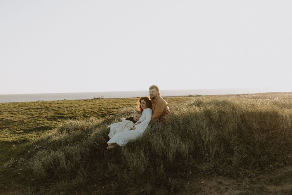 A series of landscape photos showing a person sitting on a grassy hill during golden hour sunset.