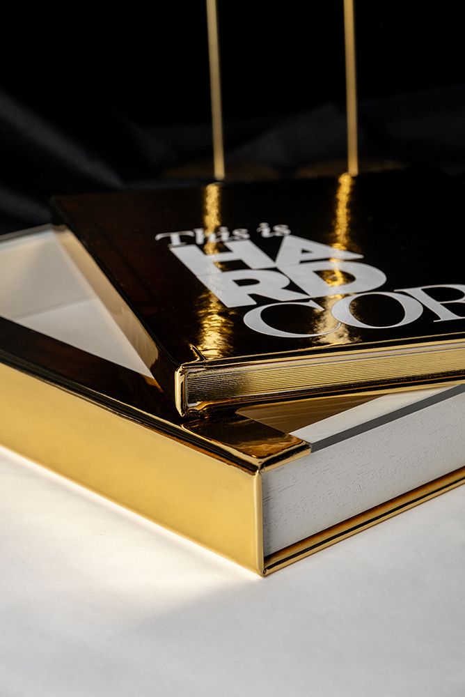 Close-up macro shots of gold and white business cards arranged in a sequence showing different angles and details.