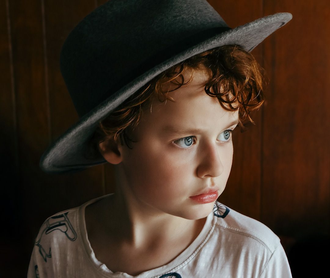A series of artistic portrait photographs showing a child in a hat photographed in NSW by Wollongong portrait photographer Serene Coleman