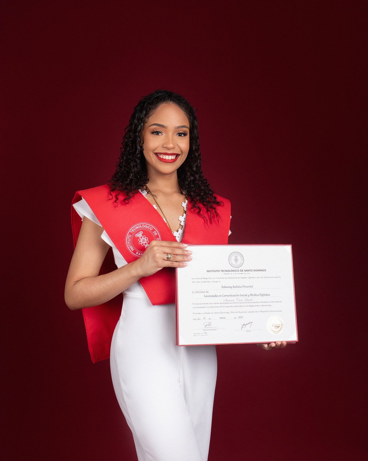 Graduate in red and black academic regalia poses with joyful expressions during graduation photo session.