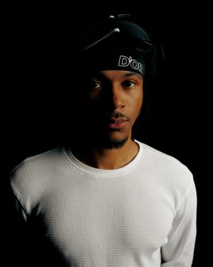 Artistic black and white portrait series showing person in white thermal shirt and black cap against dark background.