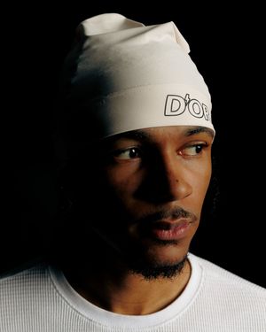 Moody portrait series showing person in white beanie and shirt against dark background.