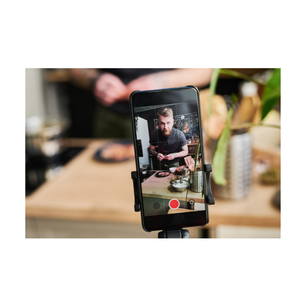 Close-up of smartphone recording video content in a kitchen setting.