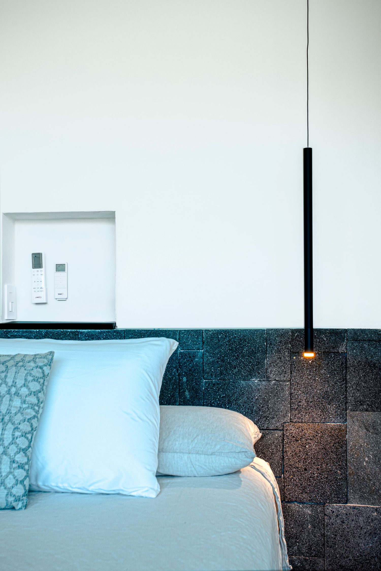 Luxury villa with a contemporary facade, featuring large glass panels and natural stone finishes
