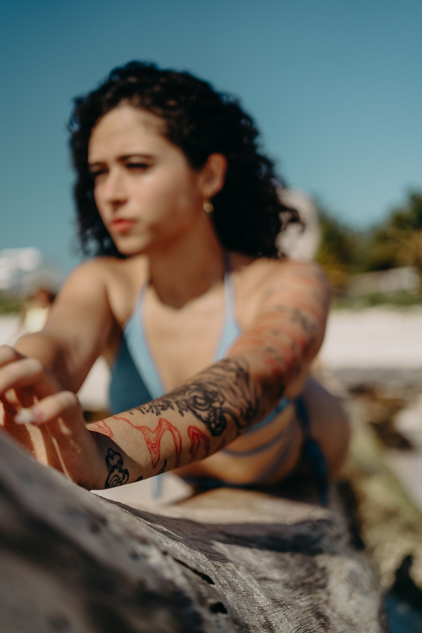 Close-up of detailed arm tattoo sleeve against beach background photoshoot in Puerto Morelos.