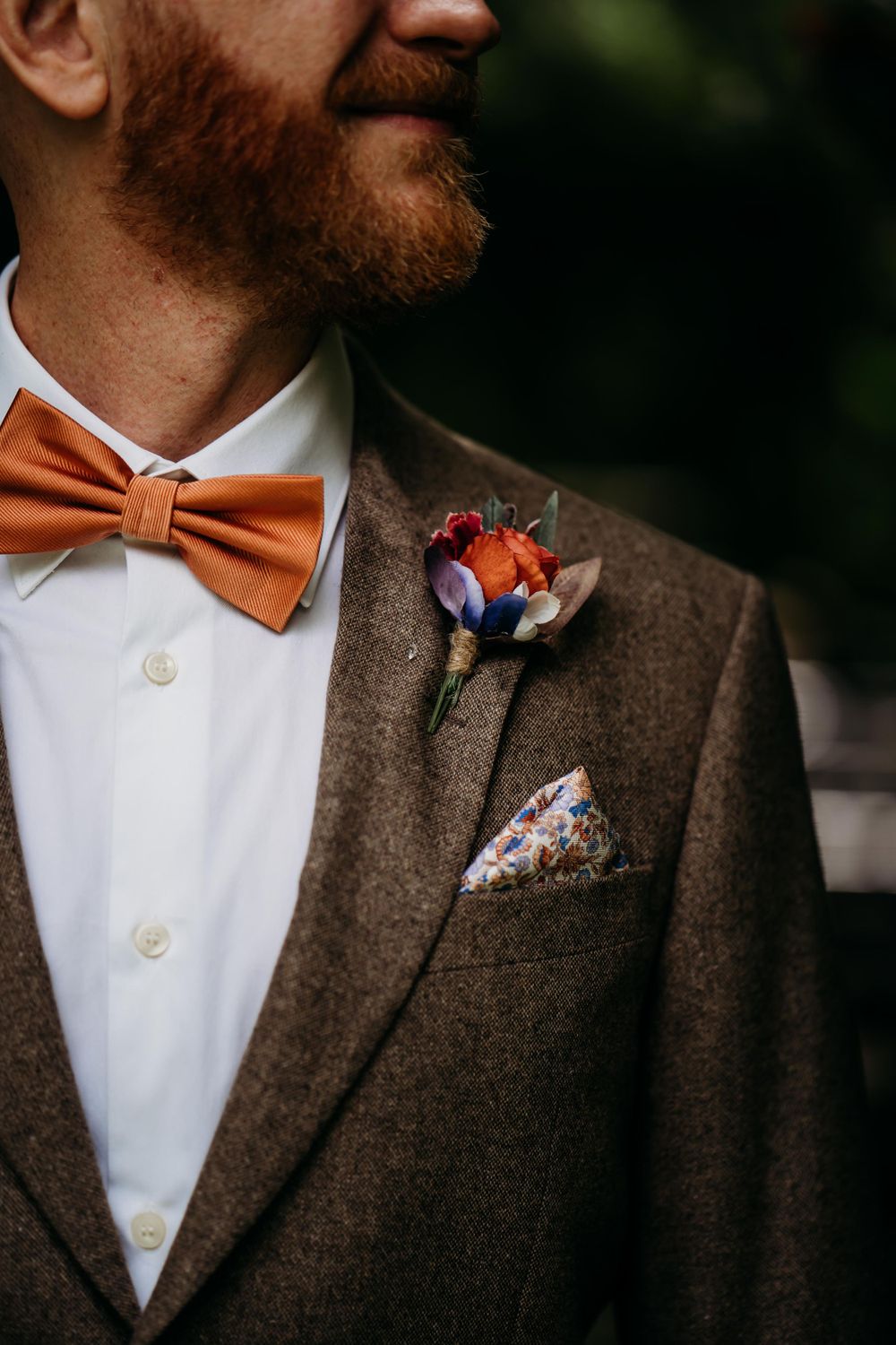 Groom-portrait-outside-the-tree-church-button-hole-close-up