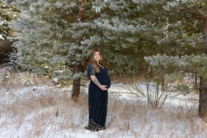 pregnant woman holding belly in winter