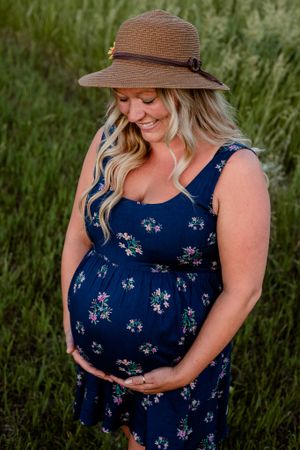 beautiful mama looking at pregnant belly with big smile