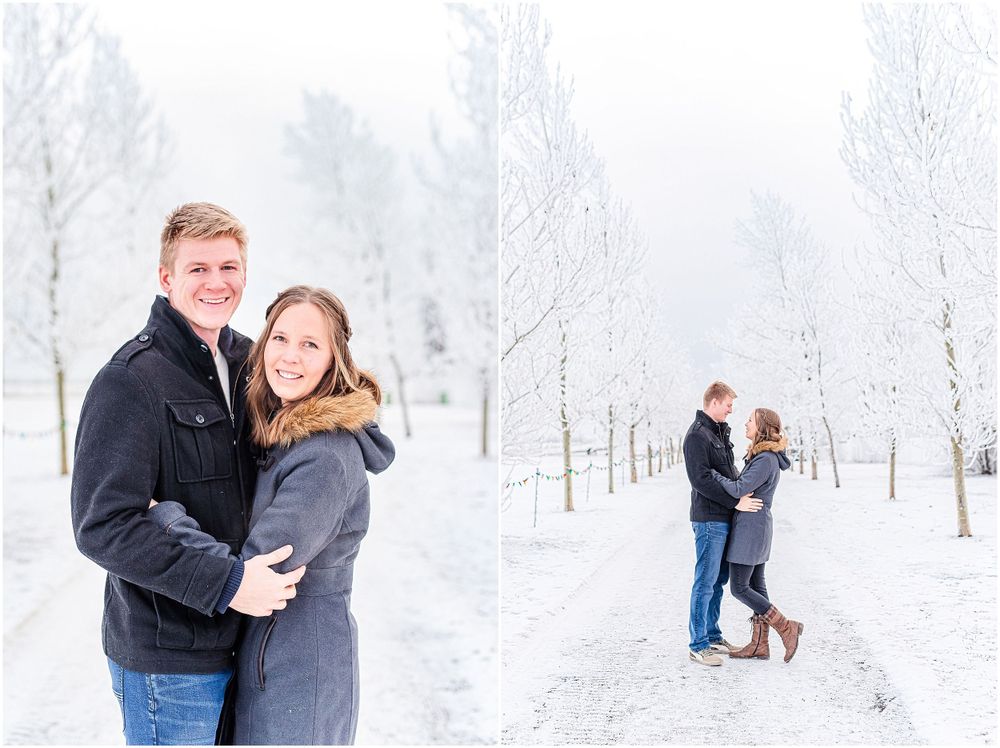 Couple sharing romantic moments in a snow-covered winter landscape with white trees.