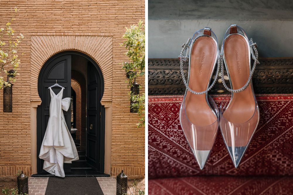 Wedding dress hangs in brick archway beside elegant silver pointed-toe bridal heels on red patterned carpet.