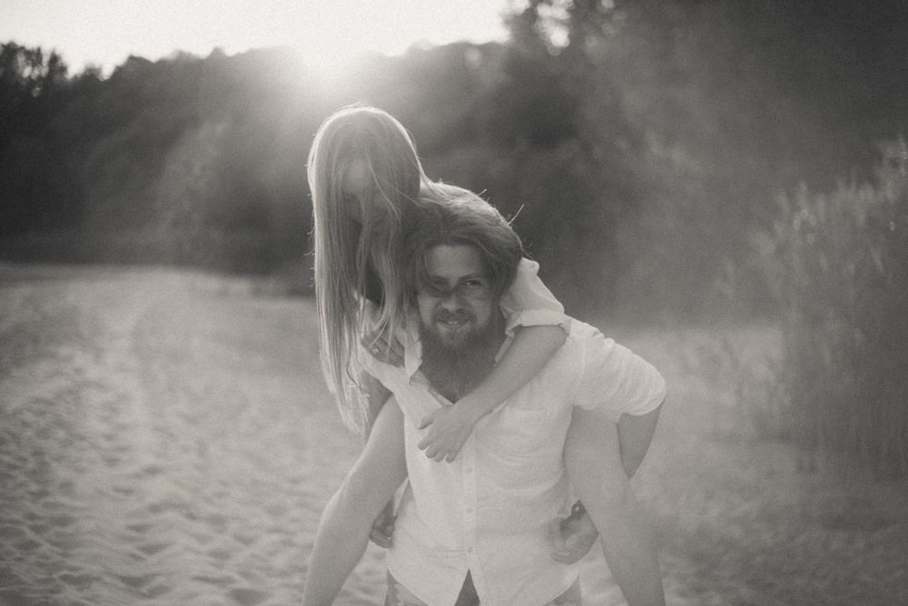 Dreamy sunlit sequence of figures embracing in a natural outdoor setting.