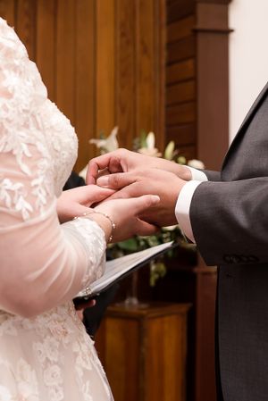 A close up image of a bride and groom exchanging their wedding rings during their ceremony at Milner Church in Langley, BC.