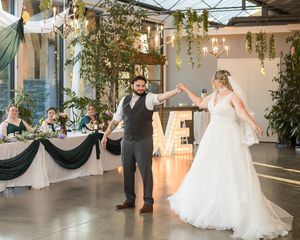 A bride and groom twirl during their first dance on their wedding day. Photo by Kari Mills Photography in Vancouver, BC.