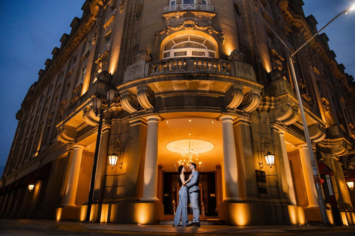 Elegant architectural entrance with warm lighting creates dramatic nighttime atmosphere.