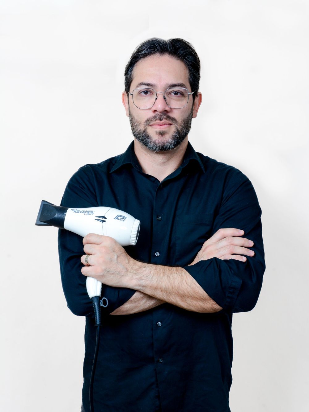 Series of poses with person in black shirt holding hair styling tools against white backdrop.