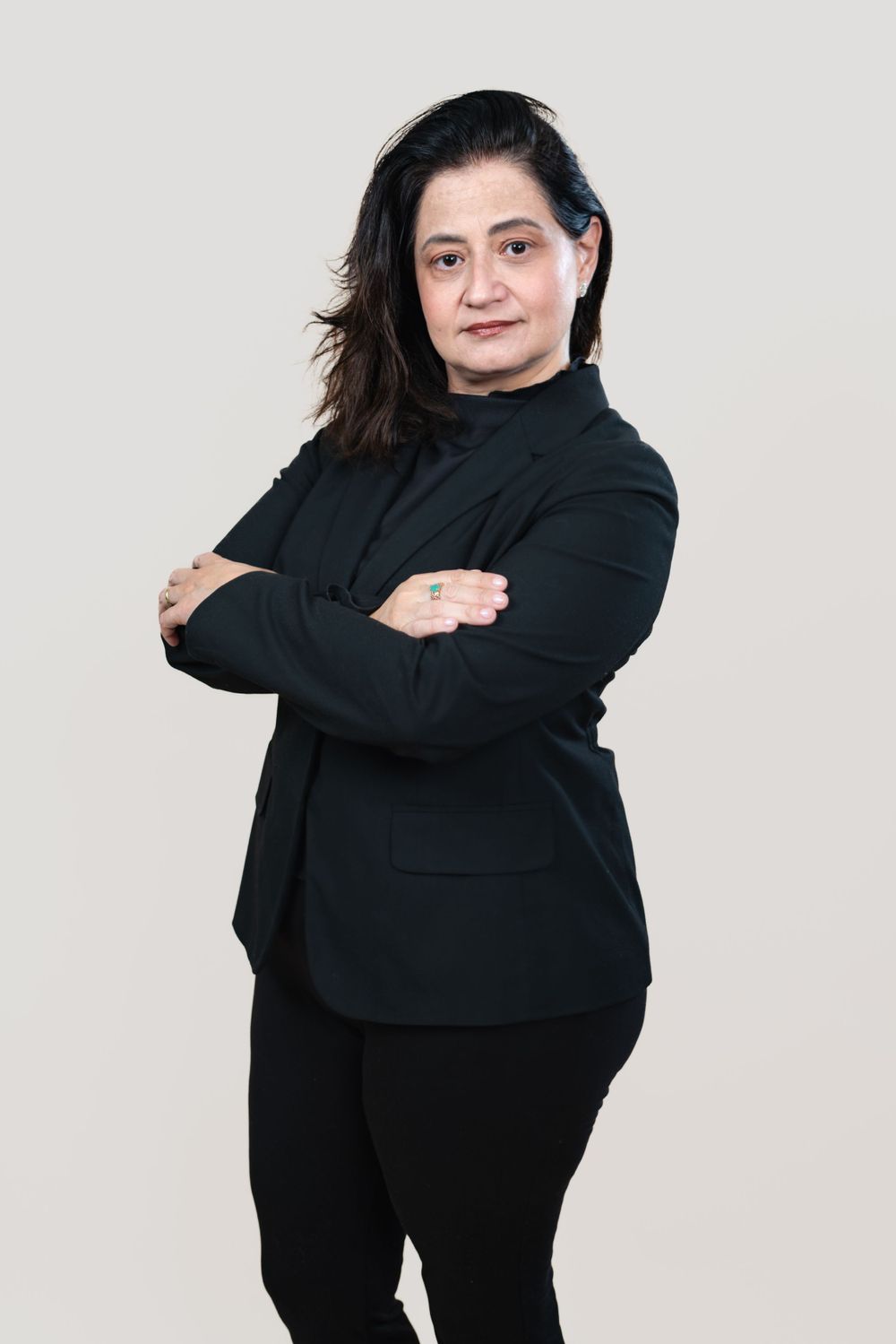 Dynamic poses of person in all black outfit against light grey background.