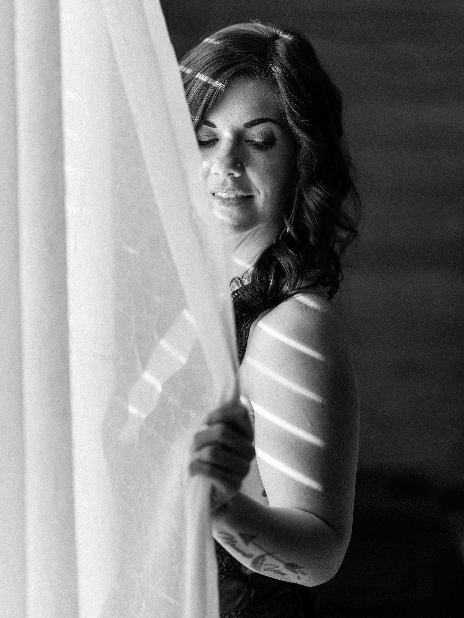 Boudoir portrait of a Knoxville woman by a window taken by dandridge TN boudoir photographer for her birthday photo session