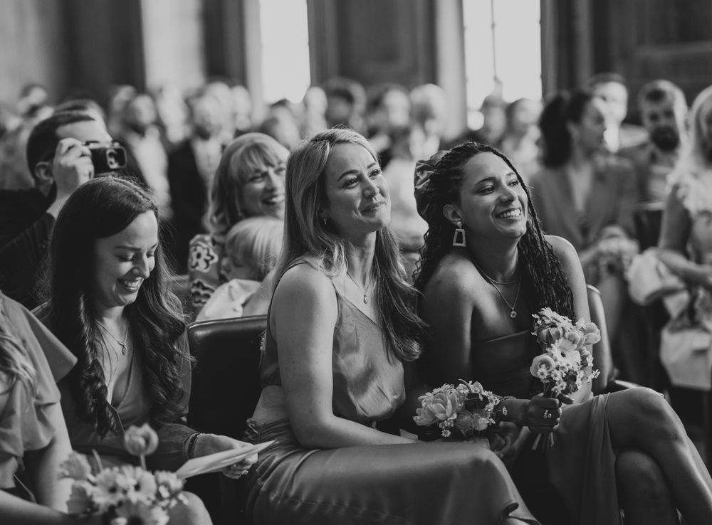 Wedding guests laughing and enjoying themselves during the ceremony.