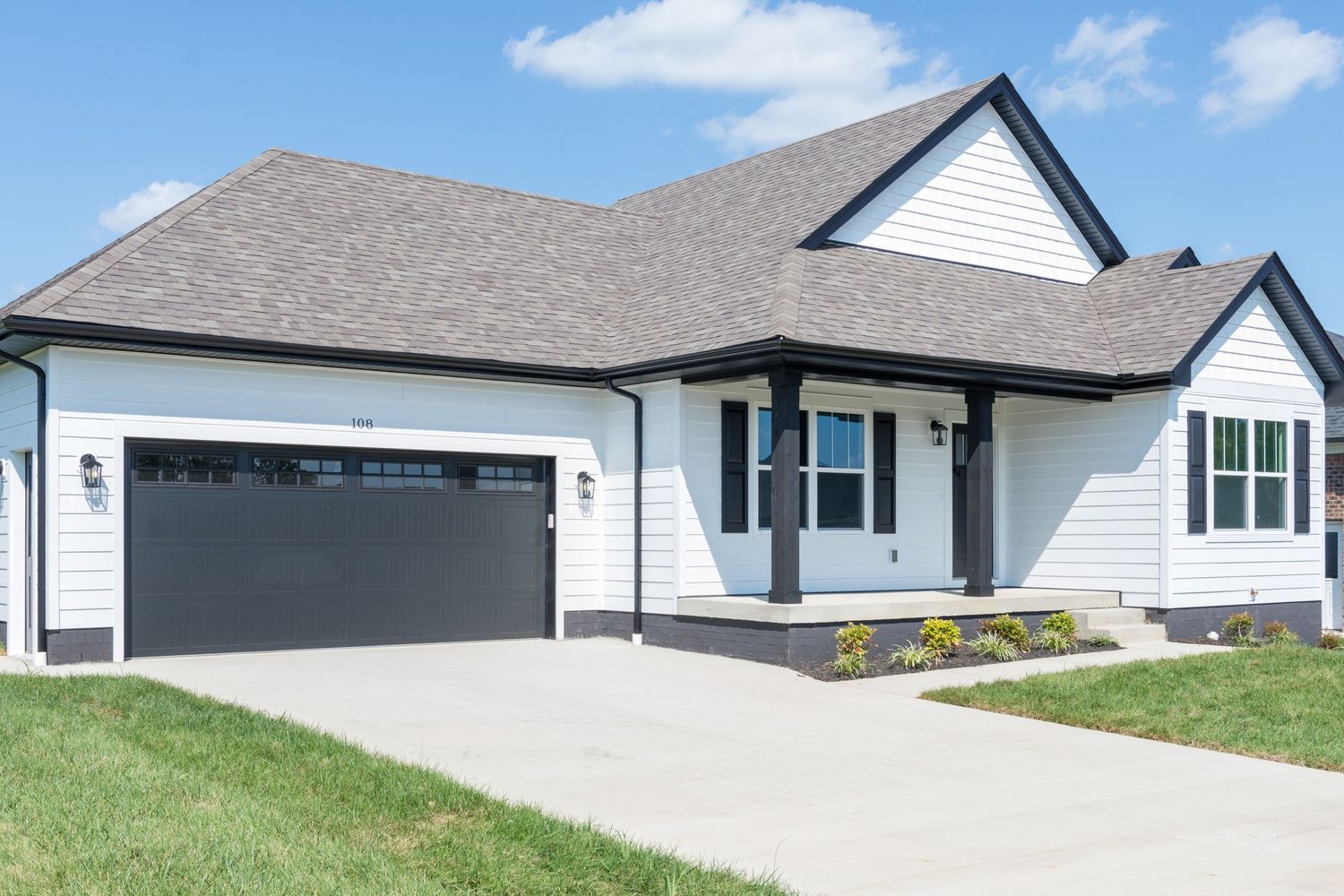 Modern ranch style home with attached two-car garage and gray roof.