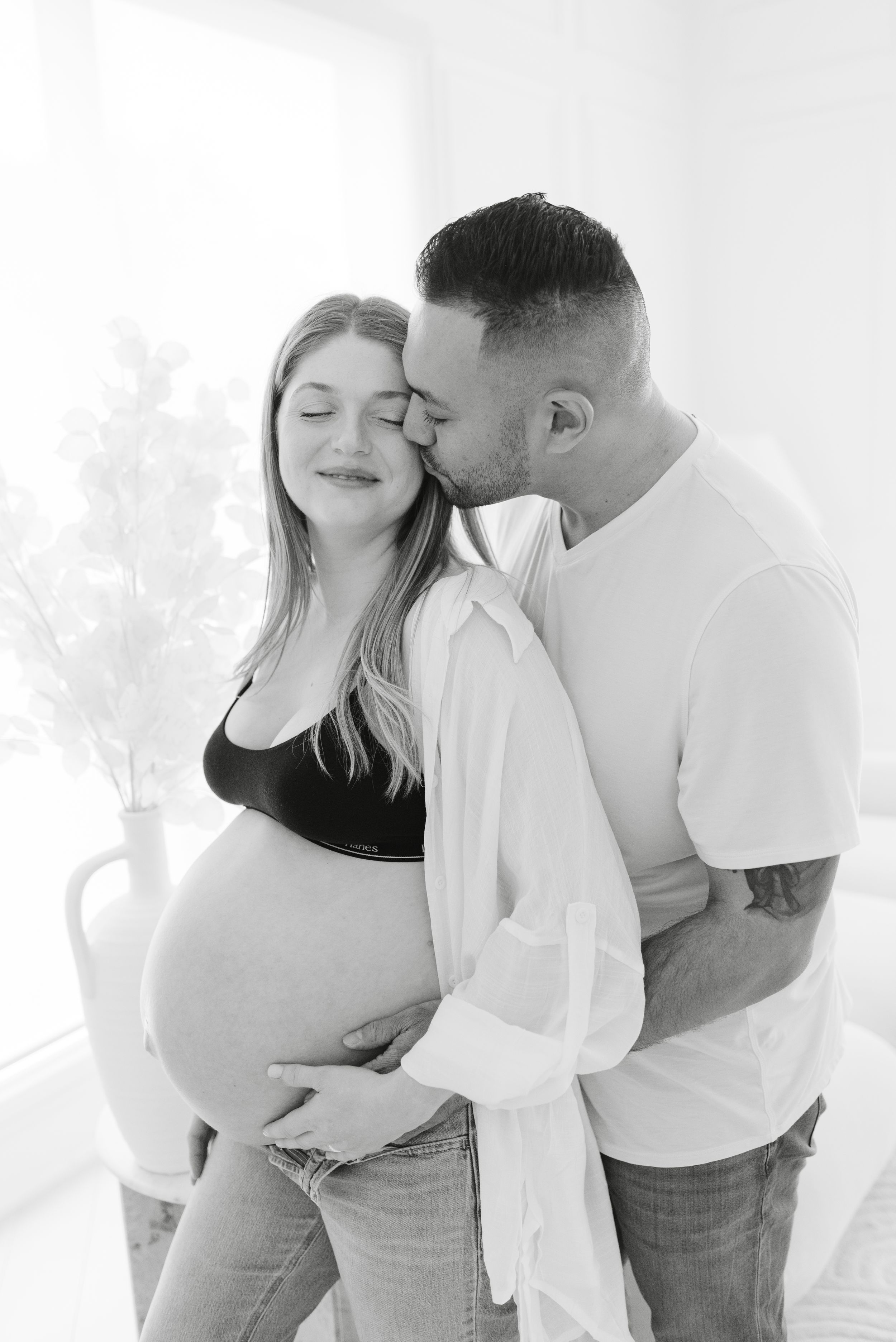 Toronto Mom and Dad kissing for maternity photoshoot at Mint Room Studio by Jess GC Photography