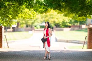 Walkway through lush green campus grounds with trees providing natural shade.