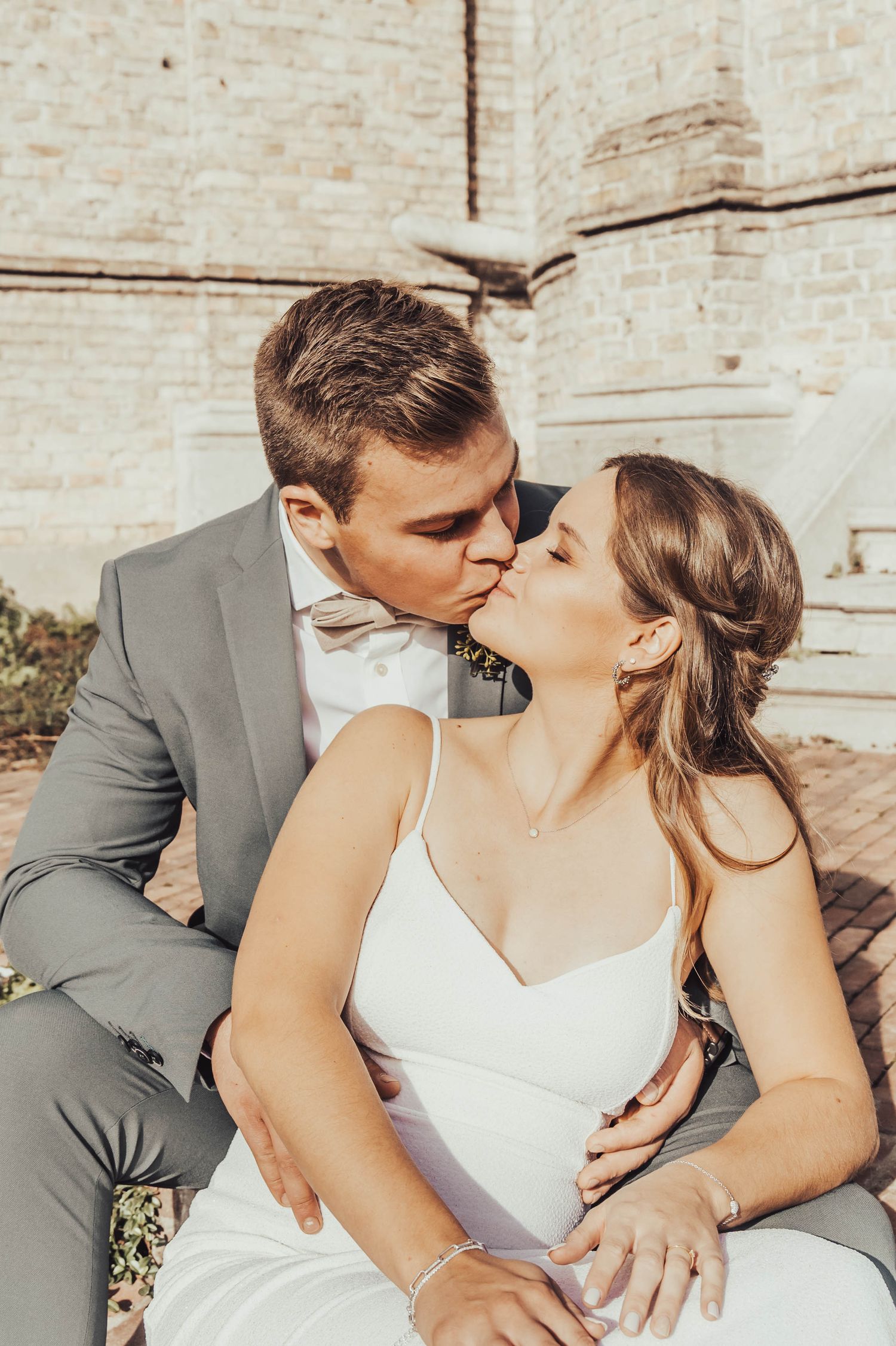 A romantic wedding portrait of a couple in formal attire sharing an intimate moment.