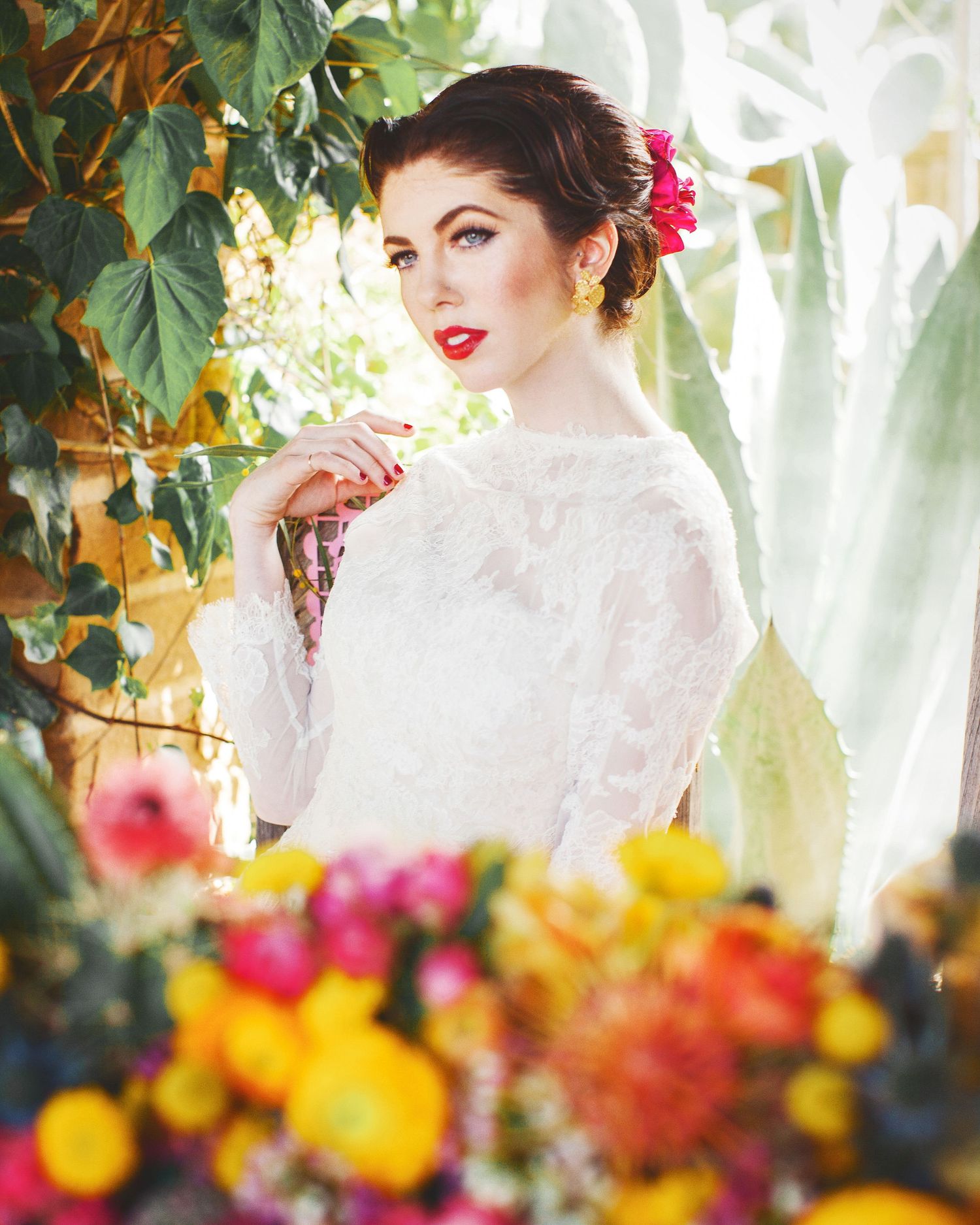 Vintage-styled portrait among colorful flowers and foliage in garden setting.