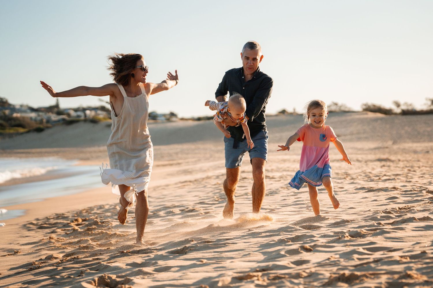 family-is-running-towards-the-camera-on-the-beach-during-a-family-photoshoot-in-sydney