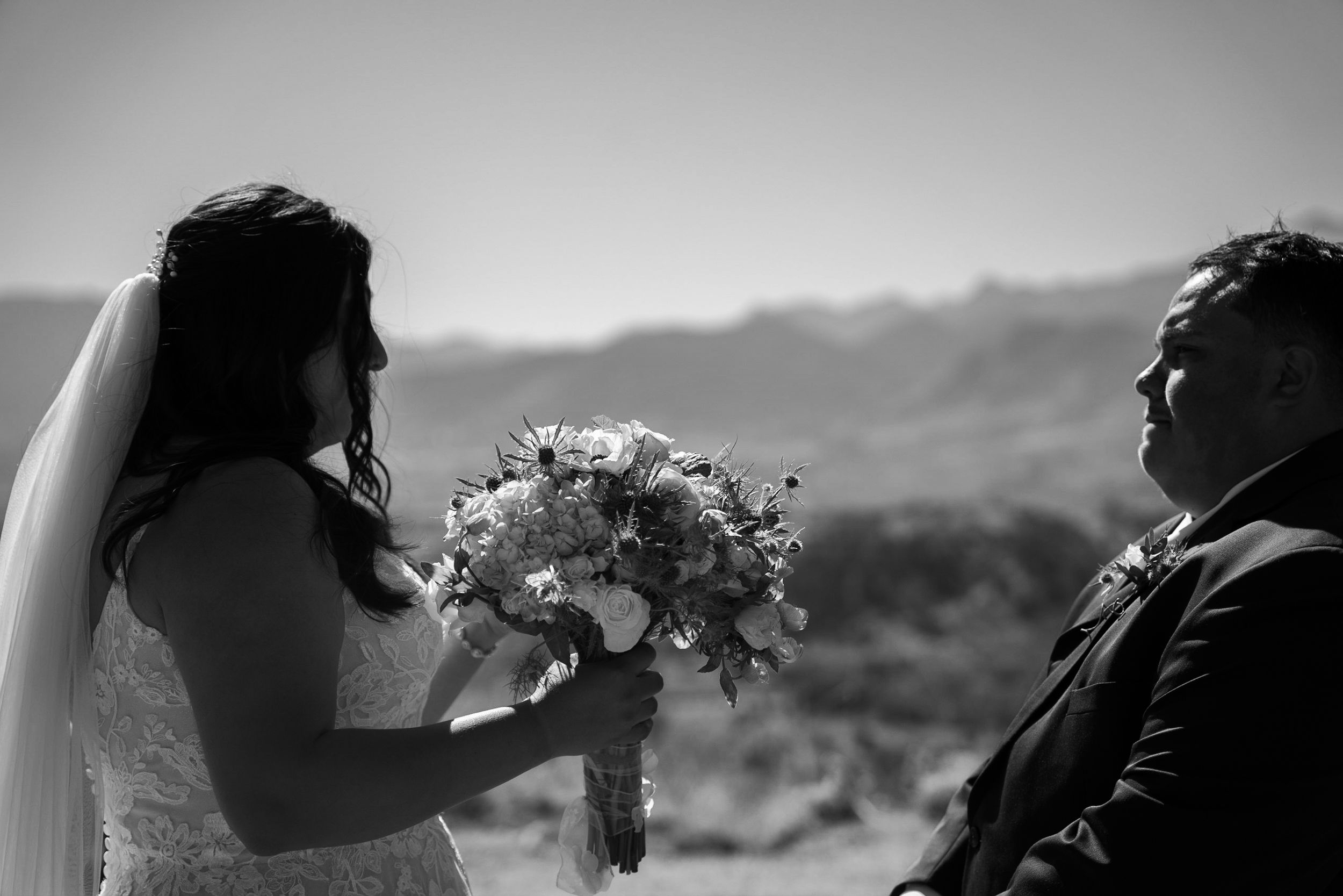 A black and white wedding photo montage showing intimate moments between a couple on their special day.