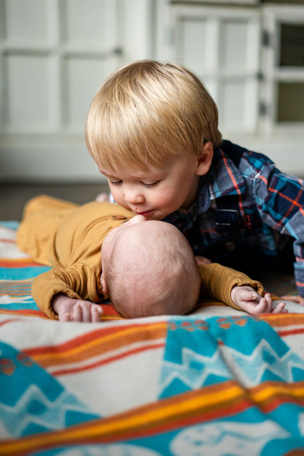 big brother kisses newborn brother