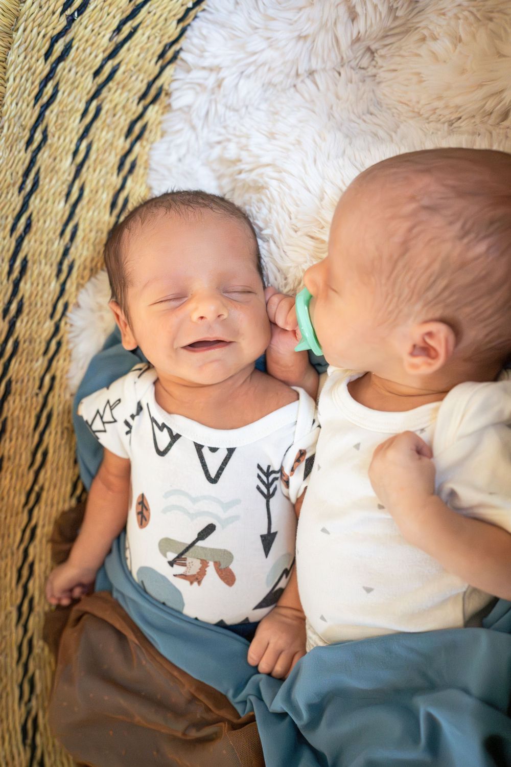 baby boy smiles at twin brother