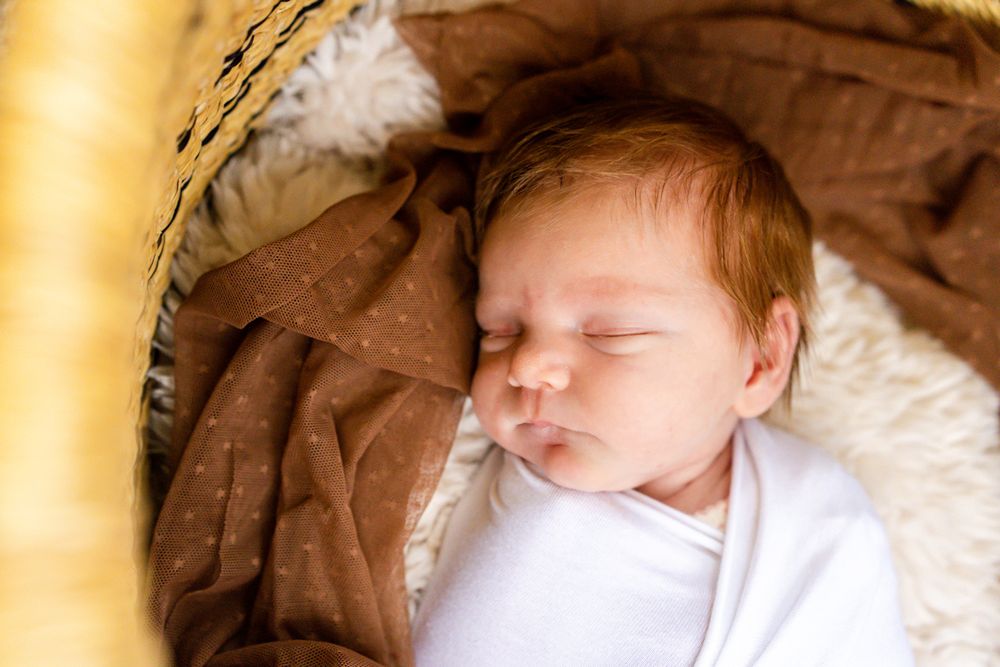 baby girl sleeping in the basket bed