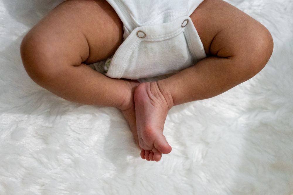 baby girl's legs curled up