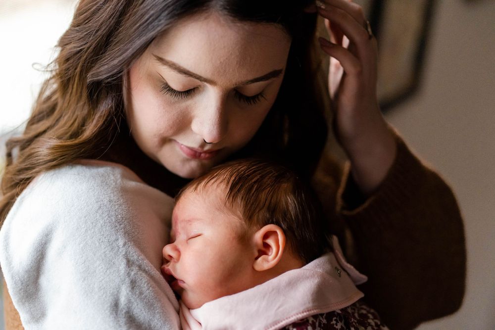 mom holding newborn daughter