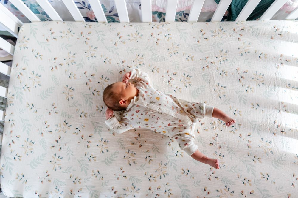 baby girl in her white crib