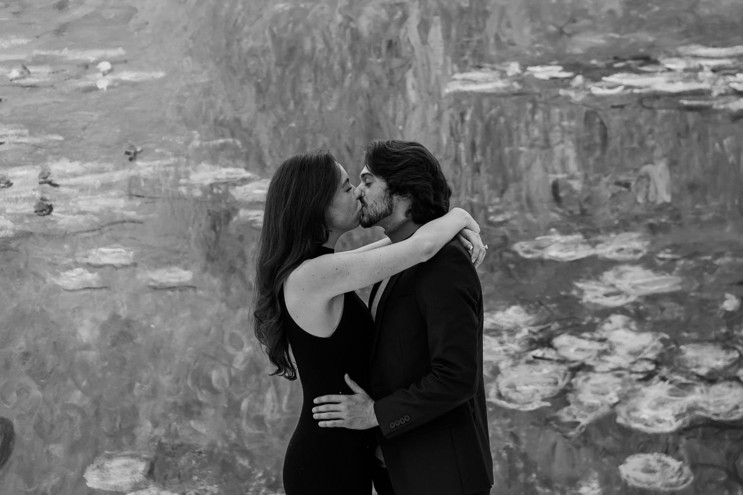 Black and white engagement photos with a lily pond background.