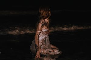 Model posed at night on beach
