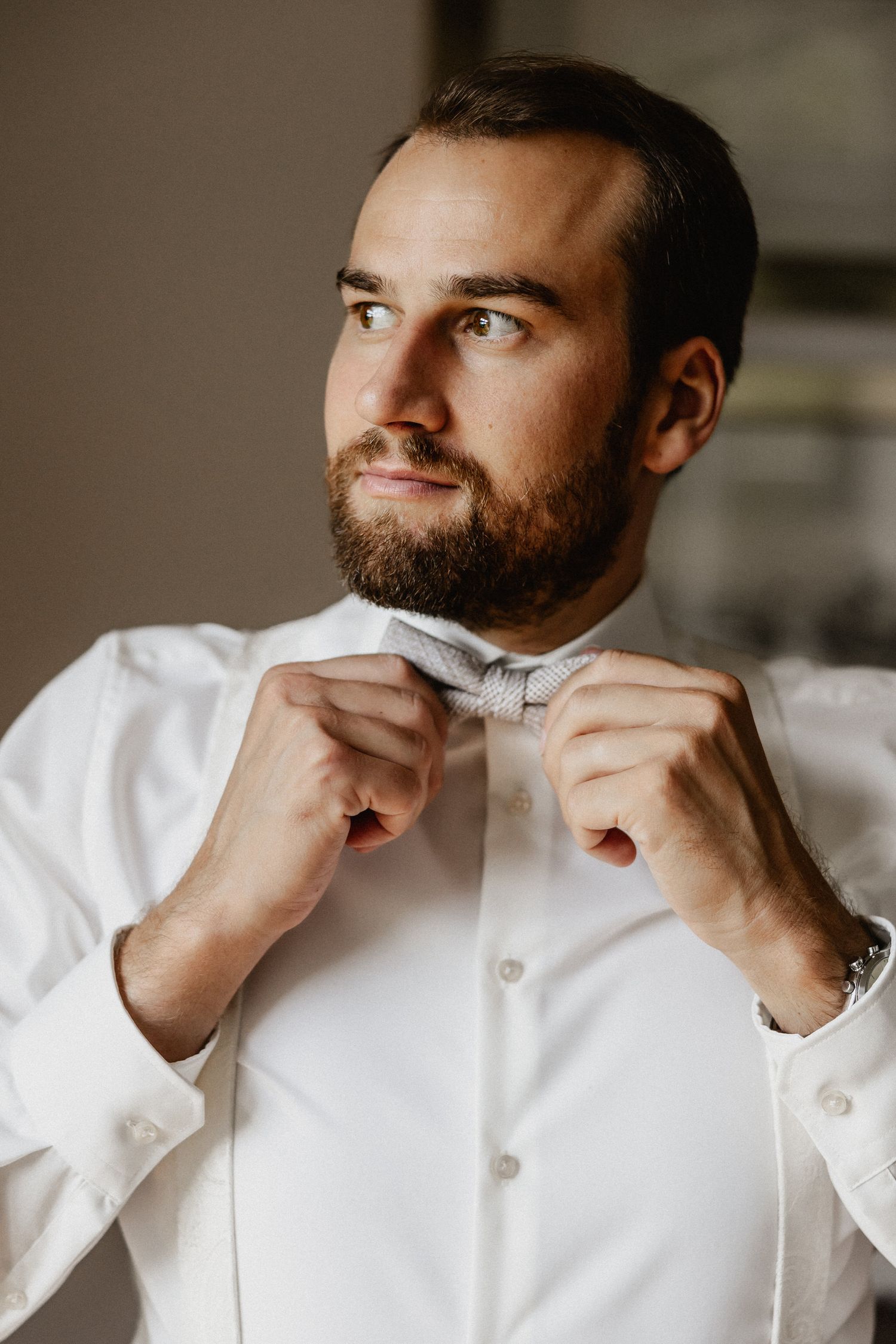 Series of shots showing white dress shirt collar being adjusted.
