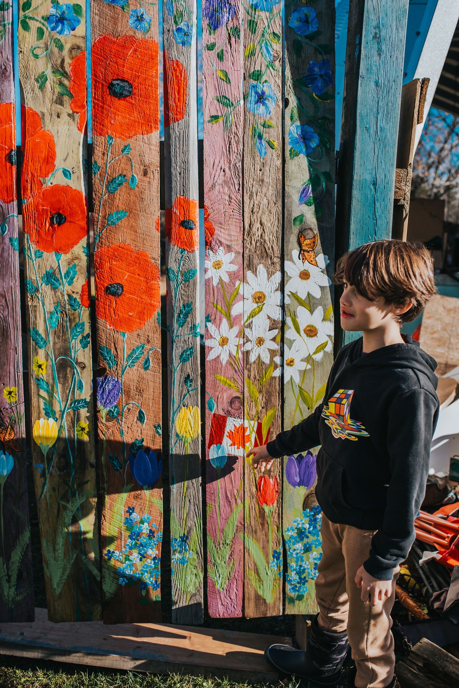 A young boy points at the Canadian Flag at Healing Minis Farm School
