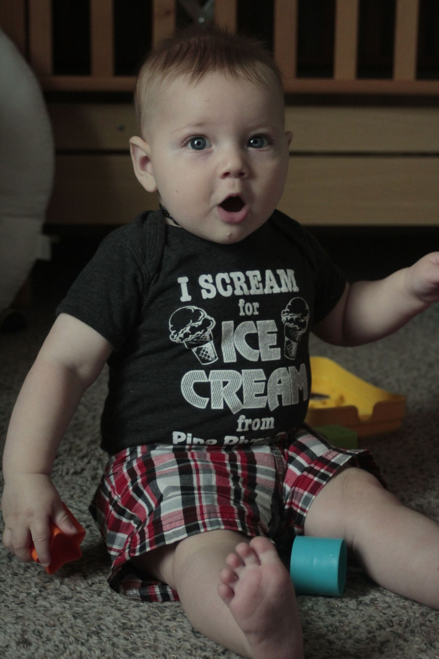 Image of a baby boy playing with some toys.