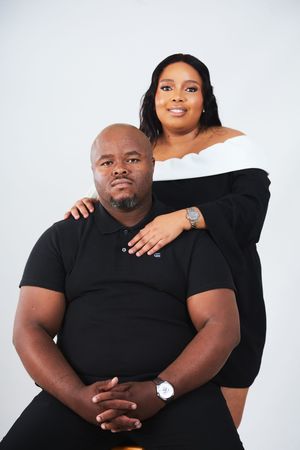 A couple wearing black poses together against a white backdrop in a series of intimate portrait photos.