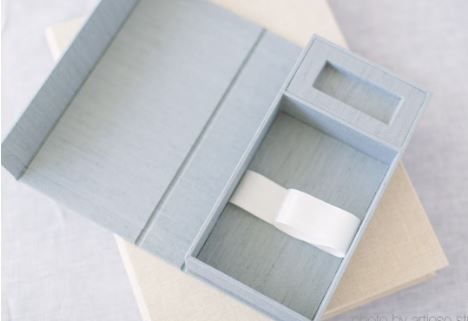 A light gray plastic multi-compartment organizer box with dividers showing storage sections.