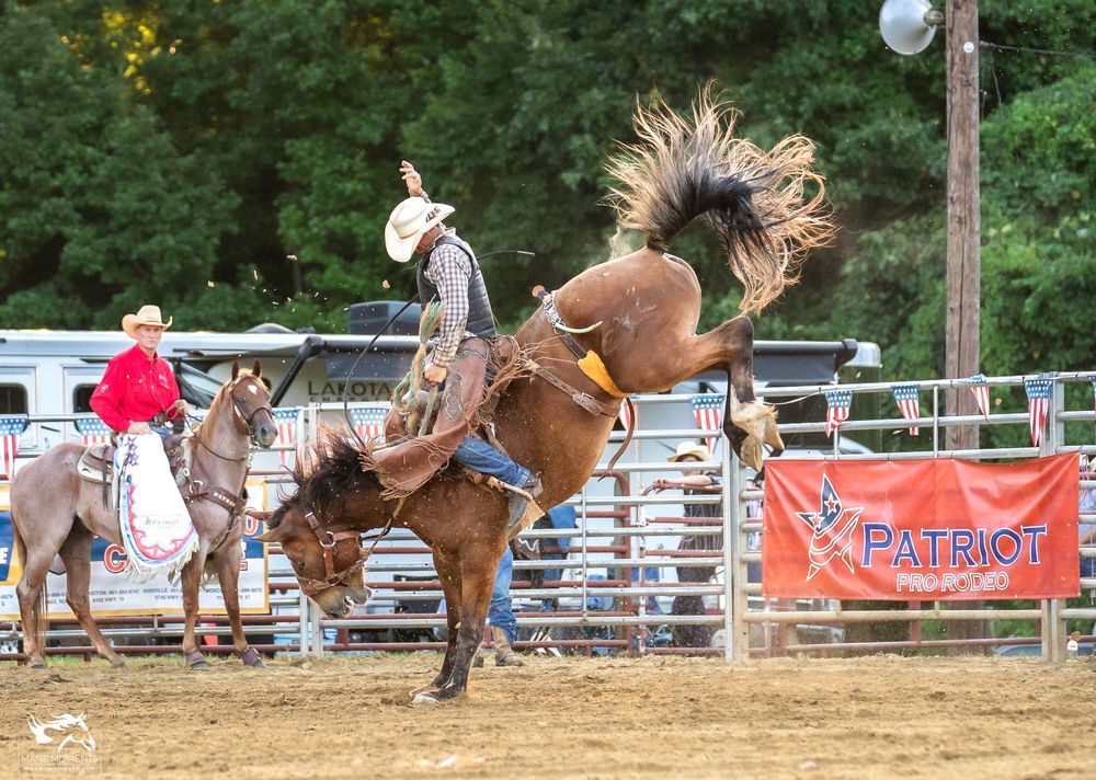 Rodeo bronc rider attempts to stay mounted on a bucking horse during an intense competition at a western event.