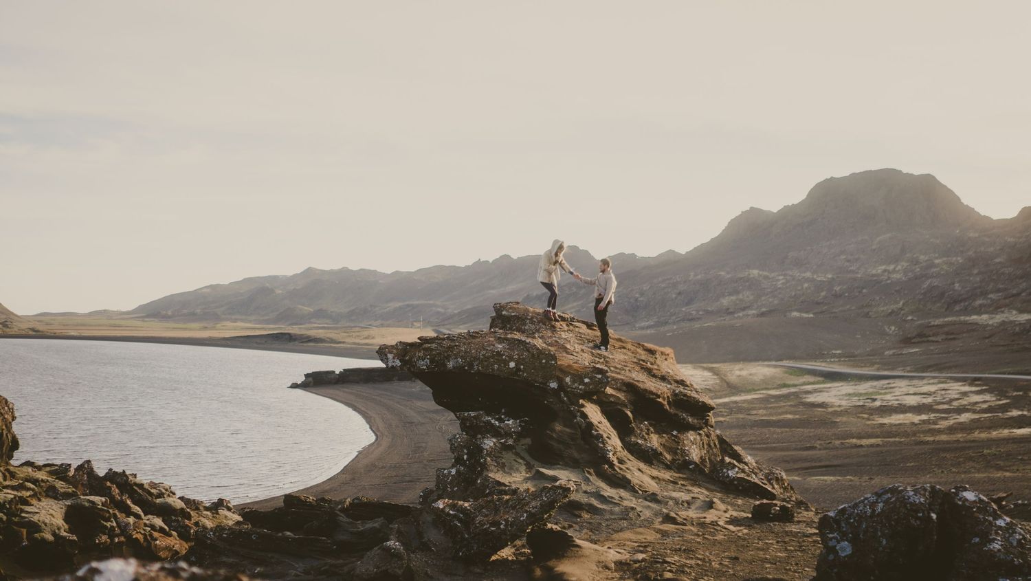 Panoramic view of a coastal mountain landscape at sunset.