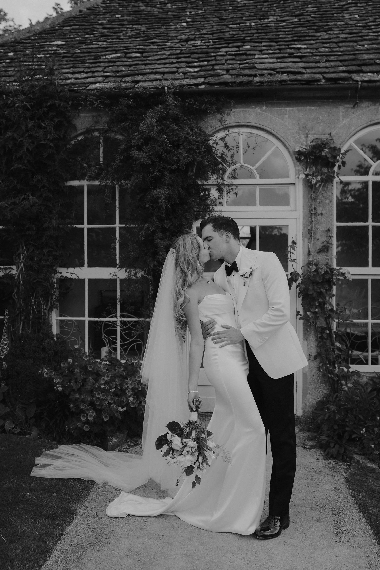 bride and groom kissing outside the orangery at hamswell house in bath