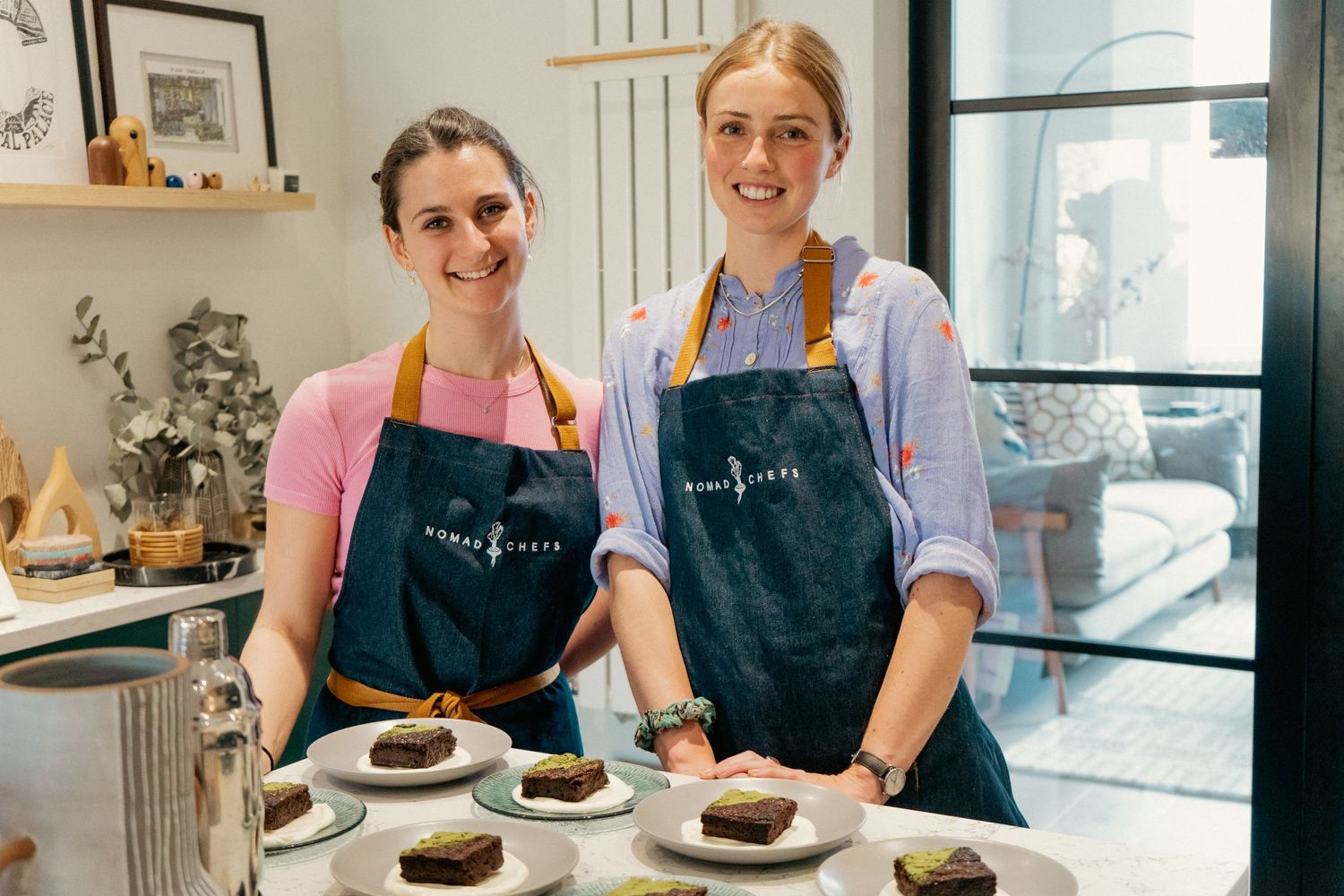 Portrait of two private chefs in aprons at a dinner event. Event photography