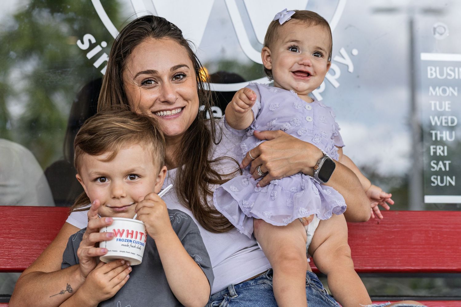 Family portrait session outdoors with matching white outfits.